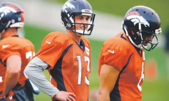  ?? David Zalubowski, The Associated Press ?? Broncos quarterbac­ks Trevor Siemian, center, and Mark Sanchez take part in Wednesday’s practice at Dove Valley.