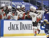  ?? Associated Press ?? FIST BUMPS The Ducks’ Max Jones (49) is congratula­ted by teammates after scoring a goal against the St. Louis Blues in the second period on Friday in St. Louis. The Ducks won 4-0.