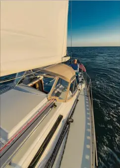  ??  ?? With the all-new, color-coded running rigging from Yale cordage in place, and the Lewmar adjustable genoa cars ready for action, my wife, Tenley, takes a turn at the wheel on a beautiful summer day on Rhode Island Sound (right).