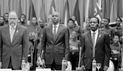  ?? FILE ?? In this February 26, 2018 file photo, Haiti’s President Jovenel Moise (centre) stands with CARICOM Secretary General Irwin Larocque, from Dominica (left) and Grenada’s Prime Minister Keith Mitchell, during the 2018 CARICOM Summit in Port-au-Prince, Haiti.
