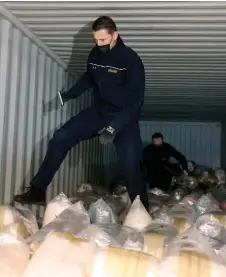  ?? — AFP file photo ?? Belgian customs officers search for drugs in a container at the port in Antwerp.