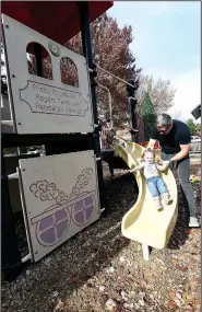  ?? NWA Democrat-Gazette/FLIP PUTTHOFF ?? Matt Burgess of Rogers plays with his daughter, Zoe, 1, on Saturday at Frisco Park in downtown Rogers. The park will be redesigned and renamed Railyard Park.