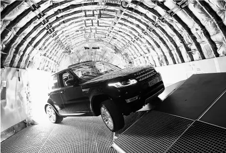  ??  ?? David Booth excitedly manoeuvres the new Range Rover Sport though an obstacle course in a Boeing 747.