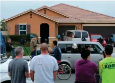  ?? AFP ?? Neighbours gather in front of a California home where authoritie­s say 13 children were held captive by their parents