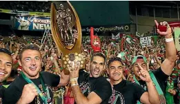  ?? GETTY IMAGES ?? Rabbitohs pose with the trophy in front of the crowd after victory during the 2014 NRL Grand Final match at ANZ Stadium in Sydney.