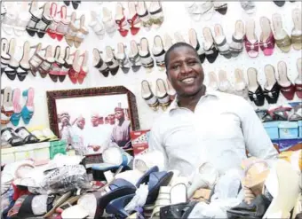  ??  ?? Bagadaza, shoe and leather works seller in Sabon Gari market, Kano