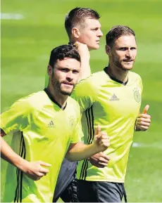  ?? PATRIK STOLLARZ/AFP/ GETTY IMAGES ?? Germany’s players warm up before practice on the eve of the team’s Euro 2016 quarter-final match against Italy. The Germans have never beaten Italy at a major tournament.