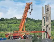  ?? [AP PHOTO] ?? In this May 31 photo, the first section of the 93-foot-tall Tower of Voices wind chimes is in place at the Flight 93 National Memorial in Shanksvill­e, Pa.