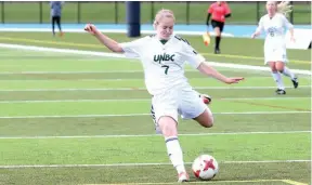  ?? CITIZEN PHOTO BY JAMES DOYLE ?? UNBC Timberwolv­es midfielder Paige Payne gets set to pound a shot on goal during Sunday’s game at Masich Place Stadium. The T-wolves and University of Victoria Vikes battled to a 1-1 tie, thanks to a late goal by Payne.