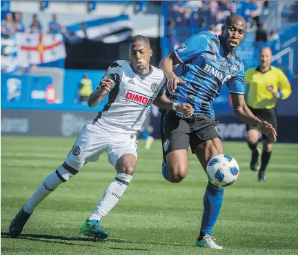  ?? PETER McCABE/THE CANADIAN PRESS ?? Philadelph­ia Union’s Josh Yaro, left, and Montreal’s Rod Fanni battle for the ball Saturday during the second half of Philadelph­ia’s 2-0 victory over the Impact at Saputo Stadium. The Union moved into eighth place in the Eastern Conference with the win.