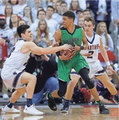  ?? RICK WOOD / MILWAUKEE JOURNAL SENTINEL ?? Brookfield East's Sam McGath tries to get the ball from Oshkosh North's Tyrese Haliburton during the Division 1 title game Saturday night.