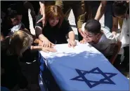  ?? (AP/Sebastian Scheiner) ?? Relatives of Israeli soldier Omer Tabib, 21, mourn at his funeral Thursday in the northern Israeli town of Elyakim. Tabib was killed in an anti-tank missile attack near the Gaza Strip, the first Israeli military death in the current fighting.