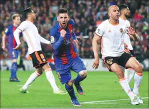  ?? MANU FERNANDEZ / AP ?? Barcelona’s Lionel Messi celebrates scoring the second of his two goals in Sunday’s 4-2 La Liga victory over Valencia at Camp Nou in Barcelona. The triumph moved Barca to within two points of leader Real Madrid.