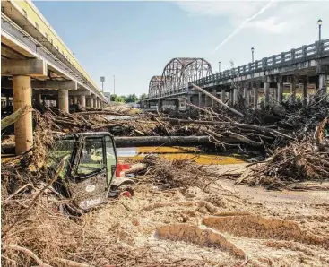  ?? Shannon Tompkins / Houston Chronicle ?? The mountains of trees, soil and detritus carried by recent flooding that swamped much of Texas coastal plain will have a mix of positive and negative effects on area waters and the fisheries in them.