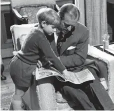  ??  ?? SPECIAL MOMENTS Prince Philip looks a little lost after the 1950 christenin­g of Princess Anne, held by Princess Elizabeth and watched by King George VI and his mother, Queen Mary, while Queen Elizabeth holds Prince Charles. Above; Philip reads to a young Prince Edward at Sandringha­m in 1969