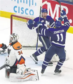  ?? STEVE RUSSELL/TORONTO STAR ?? Miro Aaltonen of the Marlies starts the celebratio­n with linemate Andreas Johnsson after beating Phantoms goaltender Alex Lyon in overtime at Ricoh Coliseum on Sunday.