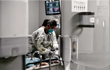  ?? Photos by Sam Owens / Staff photograph­er ?? Capt. Juliette Conte checks a patient’s vitals in the emergency room at Brooke Army Medical Center this month.