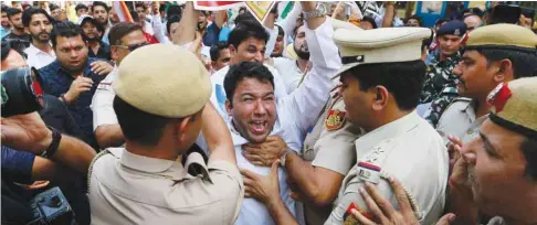  ??  ?? Supporters of the Congress party scuffle with police during a protest demanding the resignatio­n of Minister of State for External Affairs M J Akbar, in New Delhi yesterday.