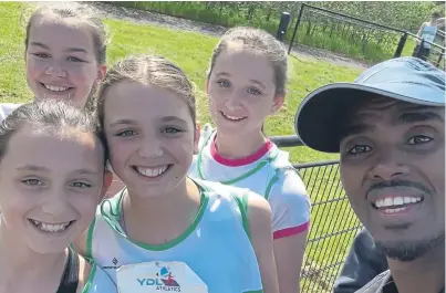  ?? ?? Sir Mo Farah with four of Chichester Runners’under-11s at the Woking match