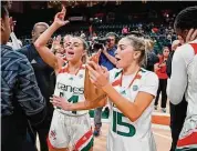  ?? Al Diaz/TNS ?? Miami’s Haley Cavinder (14) and Hanna Cavinder (15) celebrate after the Hurricanes defeated Florida State at the Watsco Center on Feb. 9 in Coral Gables, Fla.