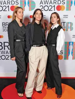  ??  ?? In a handout picture released by the Brit Awards HAIM winners of the Internatio­nal Group award pose on the red carpet.