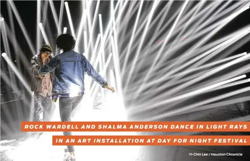  ?? Yi-Chin Lee / Houston Chronicle ?? ROCK WARDELL AND SHALMA ANDERSON DANCE IN LIGHT RAYS IN AN ART INSTALLATI­ON AT DAY FOR NIGHT FESTIVAL