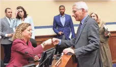  ?? GETTY IMAGES ?? Dr. Anthony Fauci fist-bumps Rep. Debbie Wasserman Schultz, D-Fla., at a House committee hearing in March.