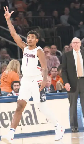  ?? Mary Altaffer / Associated Press ?? UConn’s Christian Vital (1) and Syracuse head coach Jim Boeheim react after Vital hit a 3-point goal during the 2K Empire Classic on Thursday at Madison Square Garden in New York. UConn won 83-76.