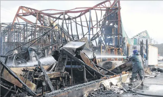  ?? ROSIE MULLALEY/THE TELEGRAM ?? Hot spots could still be seen Friday afternoon in the rubble of the O’donnell’s fish plant. The building, which employed up to 80 people, was destroyed by a fire that broke out early Friday morning.