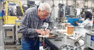  ?? DON LEE / LOS ANGELES TIMES ?? Employee Jim Blanchard works on a coil at RoMan Manufactur­ing, a maker of transforme­rs and other power sources.