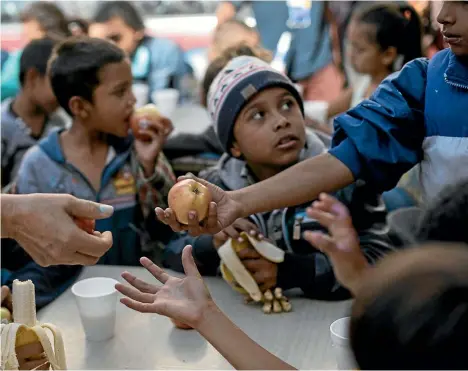  ??  ?? Children have breakfast at a migrant shelter in Tijuana, Mexico. The US Department of Health and Human Services testified last month that it had lost track of 1475 children who crossed the US-Mexico border on their own.