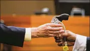  ?? ALYSSA POINTER / ALYSSA.POINTER@AJC.COM ?? The gun used in the shooting of Diane McIver is shown at the murder trial of Claud “Tex” McIver on Friday.