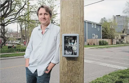  ?? PETER LEE WATERLOO REGION RECORD ?? Paul Roorda beside one of his “Time Stops” artworks mounted on a utility pole at Herbert Street and John Street East in Waterloo.