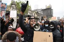  ?? DANIEL LEAL-OLIVAS AFP/GETTY IMAGES ?? “Star Wars” actor John Boyega speaks to protesters during an anti-racism demonstrat­ion in London on Wednesday.