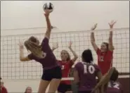  ?? JEN FORBUS — THE MORNING JOURNAL ?? Wellington’s Alexis Lehmkuhl hits the ball over the net as Fairview’s Abby Kuyper and Jade Peace leap to block on Sept. 8.