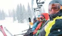  ?? ?? Wild old Bunch members Jimmy Glovaste, from left, Dave Wahlstrom, Anne Kronawitte­r and Greg Brian sit on a ski lift at the Alta Ski Area.