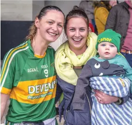  ??  ?? Player of the match Niki Brennen celebrates Tourlestra­ne’s victory with her cousin Ann Marie and her baby Conor. Pic: Tom Callanan.