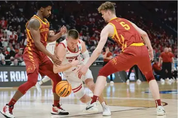  ?? MORRY GASH/AP ?? Brad Davison (center) and Wisconsin were also out early after falling to Iowa State in the second round.