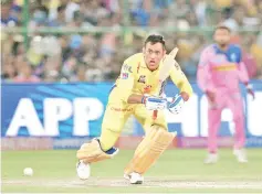  ?? — AFP photo ?? Chennai Super Kings cricketer MS Dhoni(L) plays a shot during the 2019 Indian Premier League (IPL) Twenty20 cricket match at the Sawai Mansingh Stadium in Jaipur.