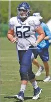  ?? AP PHOTO/MARK HUMPHREY ?? Tennessee Titans offensive lineman Corey Levin runs to a drill during training camp in July in Nashville. Levin is a former UTC standout who was drafted by the Titans in 2017.