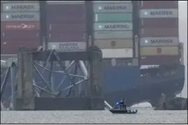  ?? MATT ROURKE — THE ASSOCIATED PRESS ?? The container ship, which was going from Baltimore to Sri Lanka, rests against the wreckage of the bridge on Thursday. It was carrying nearly 4,700metal shipping containers.