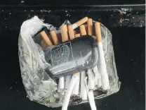  ?? FLORIDA DEPARTMENT OF CORRECTION­S/ THE ASSOCIATED PRESS ?? The Florida Department of Correction­s found a cellphone and cigarettes inside a camouflage­d package at an undisclose­d state prison. The state seized an average 11 cellphones per day in 2013.