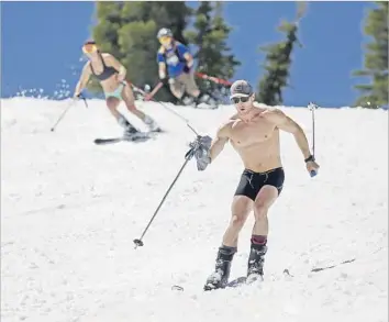  ?? Gary Coronado Los Angeles Times ?? SKIERS wearing attire more often seen at the seashore glide down the slopes at Squaw Valley Ski Resort in Olympic Valley, Calif. Months of back-to-back storms left behind as much as 200 inches of snow.