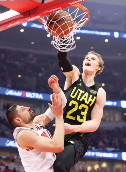  ?? GETTY IMAGES ?? The Jazz’s Lauri Markkanen dunks on the Bulls’ Nikola Vucevic on Saturday. He scored 28 points against his former team.