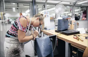  ?? PHOTO: REUTERS ?? A craftswoma­n works on a Kelly bag at the luxury goods Hermes factory in Seloncourt, France. Hermes’ sales are surging.