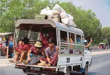  ?? AFP PIC ?? People fleeing the Hlaing Tharyar township in Yangon yesterday as security forces continue a crackdown on protests in the area against the military coup.