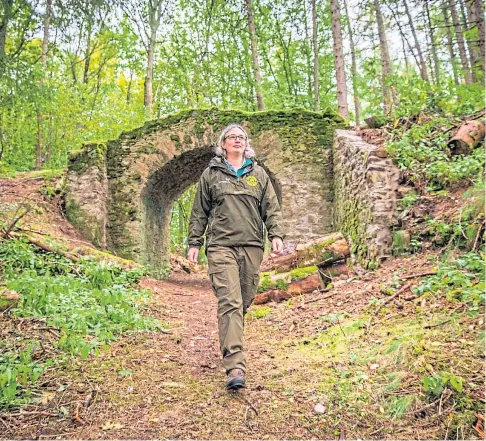  ??  ?? GRISLY HISTORY: Blair Atholl Estate ranger Julia Duncan walking part of the newly-opened trail which leads to Hangman’s Knoll, the location of the last public execution there in 1630. Picture by Steve MacDougall.