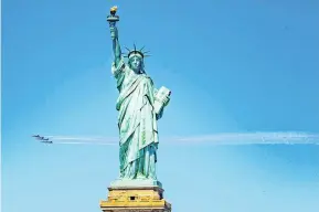  ?? PHOTO: HANDOUT VIA REUTERS ?? Wild blue yonder . . . The US Navy Blue Angels and US Air Force Thunderbir­ds demonstrat­ion teams fly past the Statue of Liberty in New York City yesterday as part a tour of US cities to honour first responders and essential workers during the Covid19 pandemic.