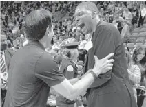  ?? ?? Former Heat center Chris Bosh, right, and Heat coach Erik Spoelstra share a moment Friday night at FTX Arena.