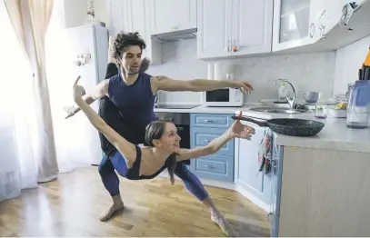  ?? Picture: AFP ?? COOKING AT HOME. Bolshoi theatre leading soloist Igor Tsvirko and first soloist Margarita Shrainer attend a lesson in their apartment in Moscow during a strict lockdown in Russia.